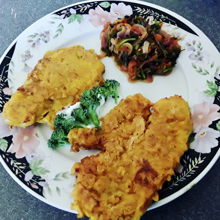 Coated fish fillet served with vegetable stew and broccoli in sour cream