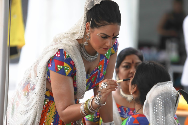 Jhoomkar dancers apply make-up for their for their act during the Cape Town Carnival.