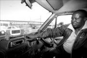 HIGH TECH: Taxi driver Daniel Buthelezi explains how the commuter card-for-payment system works. He works from the Pretoria taxi rank. Pic. Antonio Muchave. 20/06/08. © Sowetan.