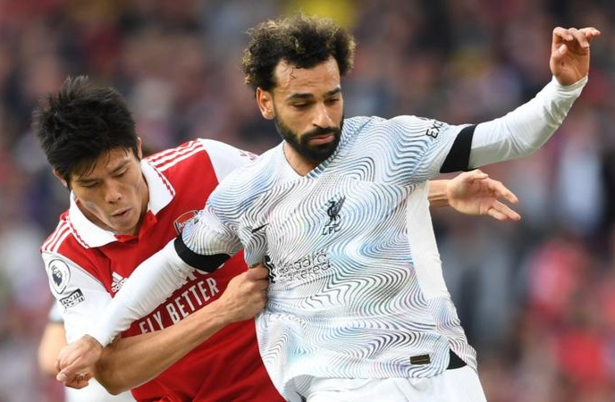 Liverpool's Mohamed Salah with Arsenal's Takehiro Tomiyasu