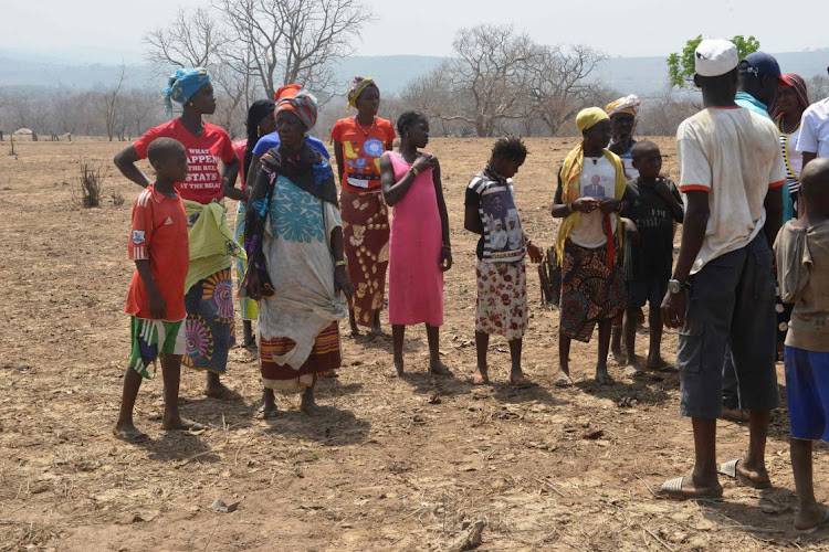 Residents stand in their village of Bouramaya Sousou, near Souapiti in Guinea, in the picture taken on March 3 2020.