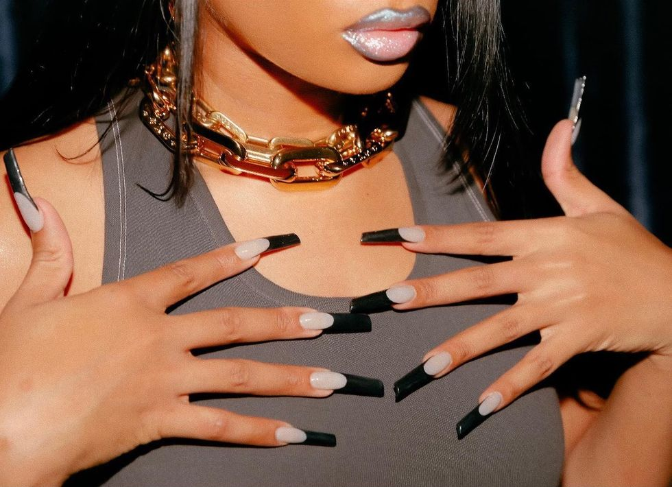 Full look of megan theee stallion white and black nails 