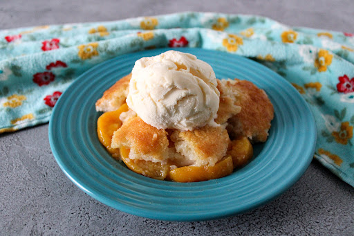 Easy Peach Cobbler with a scoop of ice cream on top.