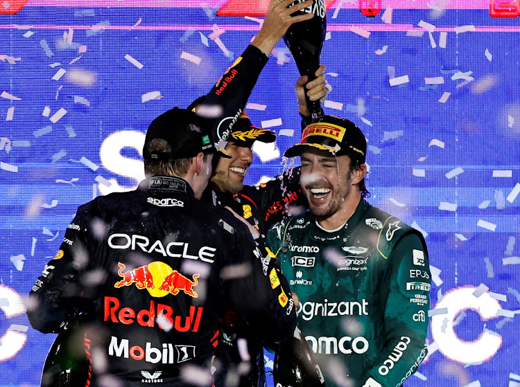 Aston Martin’s third-placed Fernando Alonso celebrates on the Saudi Arabia podium with winner Sergio Perez and second-placed Max Verstappen. Picture: REUTERS