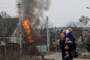 Local residents escape from the town of Irpin, after heavy shelling landed on the only escape route used by locals, as Russian troops advance towards the capital of Kyiv, in Irpin, near Kyiv, Ukraine March 6 2022.