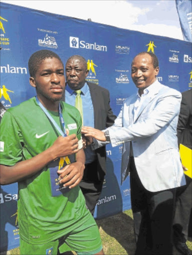 HANDS OFF: Patrice Motsepe, right, with Mamelodi Sundowns target Thuto Mphahlele who is captain of School of Excellence. PHOTO: RAMATSIYI MOHOLOA