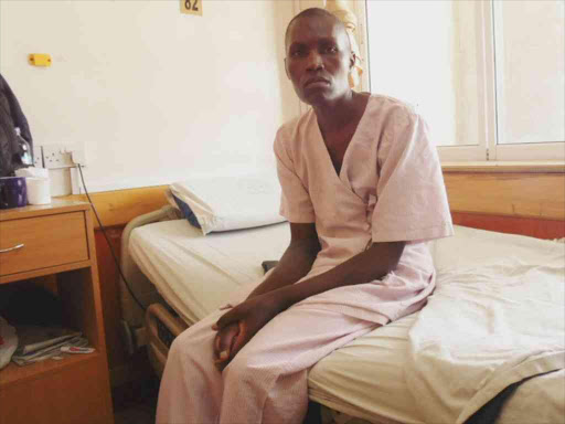 Kennedy Ouma seated at hospital bed at Nairobi West Hospital last month/JOSEPH NDUNDA