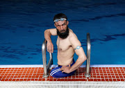 Khan Agha 28, sits in a swimming pool during his practice in Kabul, Afghanistan May 16, 2017. Picture taken May 16, 2017.