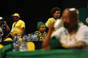 Nkosazana Dlamini-Zuma looks on as ANC party delegates break for tea during the 54th National Conference of the African National Congress. President Jacob Zuma is in the foreground. The conference was held to elect major party officials, including a new ANC president, as well as a new National Elective Committee. Dlamini-Zuma lost her bid for ANC president to Cyril Ramaphosa. 