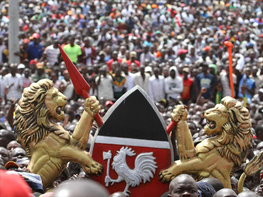 A vandalized Kenya Coat of arm being passed across the NASA supporters at Uhuru Park amid the swearing in of Opposition leader Raila Amollo Odinga at Uhuru Park on January 30,2018.Photo/Enos Teche.