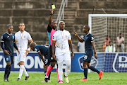 Royal AM player Andile Mpisane gets a yellow card during the DStv Premiership match against Richards Bay FC at King Zwelithini Stadium in May 2023.