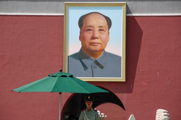 A paramilitary policeman keeps watch underneath the portrait of Chairman Mao Zedong, the founding father of the People's Republic of China, in Beijing's Tiananmen Square. Mao was the principal Chinese Marxist theorist.