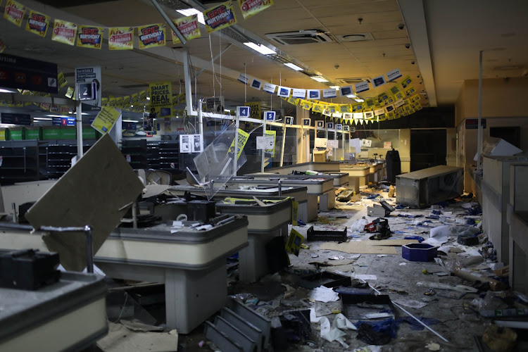 Many shops, like this one in Alexandra, were extensively damaged in the looting spree.