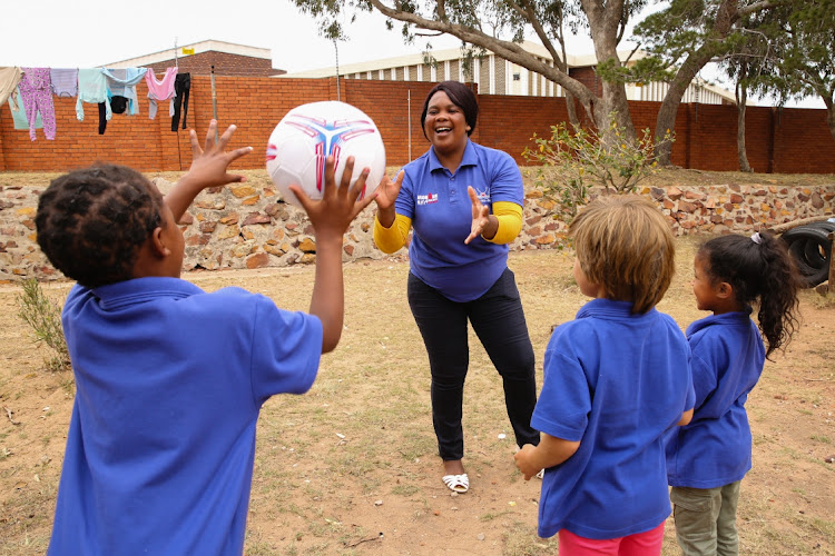 CHRISTMAS IS COMING: Child care worker Princess Ntugwana plays ball with some of the children at the EP Child and Youth Care Centre. There is a need for holiday activities and for presents for about 30 children who will be at the facility throughout the festive season