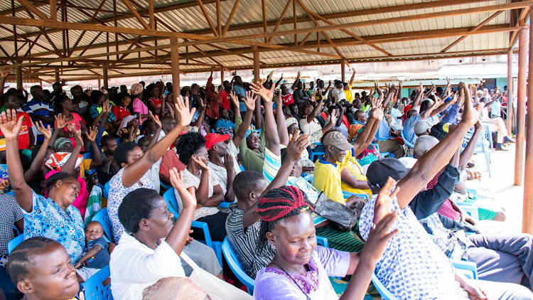 Traders at Ajigo market in Rarieda constituency, Siaya county during the launch of free public wifi hotspot on Friday