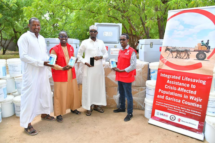 Agriculture and Livestock executive Mohamed Shale (C), Livestock director Haret Hambe and Save The Children programme manager Yussuf Gedi during the launch of livestock vaccination exercise