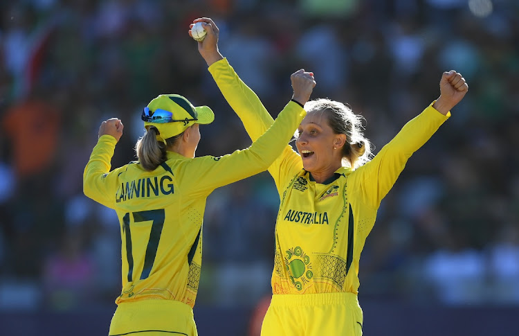 CAPE TOWN, SOUTH AFRICA - FEBRUARY 26: Meg Lanning and Ashleigh Gardner of Australia celebrates after winning the ICC Women's T20 World Cup following the ICC Women's T20 World Cup Final match between Australia and South Africa at Newlands Stadium on February 26, 2023 in Cape Town, South Africa.