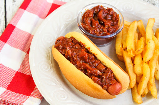 Hot Dog Onions on a hot dog with french fries.