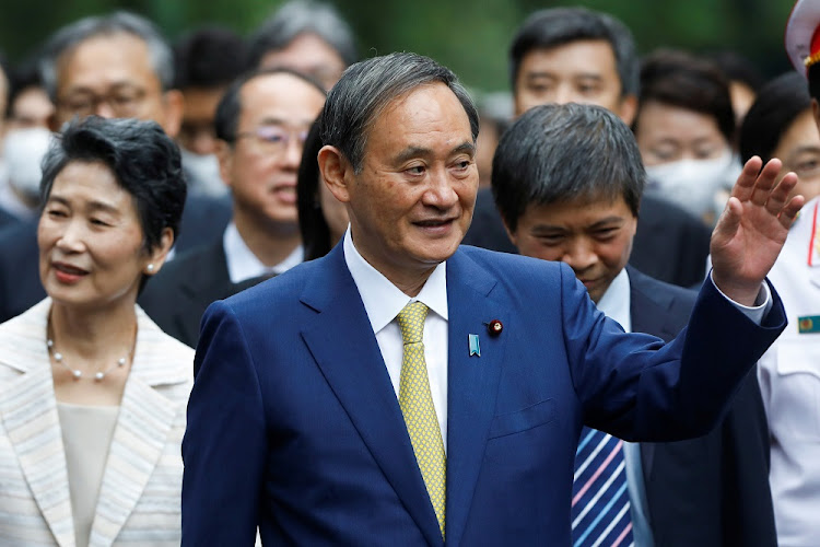 Japanese Prime Minister Yoshihide Suga waves after the welcoming ceremony at the Presidential Palace in Hanoi, Vietnam on October 19, 2020.