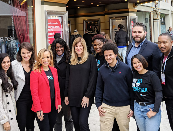 A group of ten people looking at camera