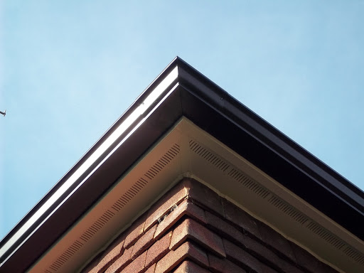 Seamless black gutter & white vented soffit