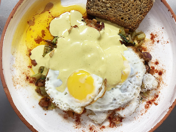 Start your day sunny side up with coconut fried eggs atop of spinach stems and some burnt butter hollandaise.