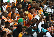 Ivory Coast captain Serge Aurier and teammates celebrate with the trophy after winning the Africa Cup of Nations final against Nigeria at Stade Olympique Alassane Ouattara in Abidjan, Ivory Coast, on Sunday night.
