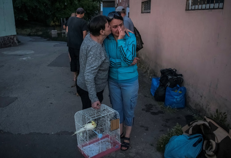 Residents react after their evacuation from a flooded area after the Nova Kakhovka dam breached, in Kherson, Ukraine, June 2023. Picture: REUTERS/Vladyslav Musiienko