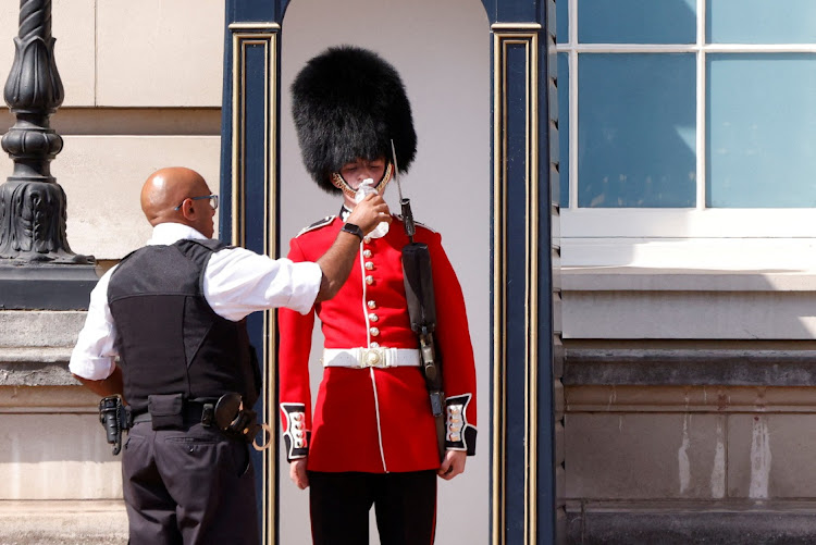 A member of the Queen’s Guard receives a drink of water outside Buckingham Palace in London during the heatwave that has gripped parts of Europe, July 18 2022. Picture: JOHN SIBLEY/REUTERS