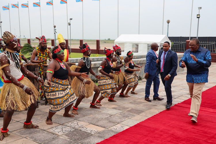 Former President Uhuru Kenyatta is received by dancer in Congo ahead of the inauguration ceremony of the president-elect Félix Antoine Tshisekedi Tshilombo on January 19, 2023.