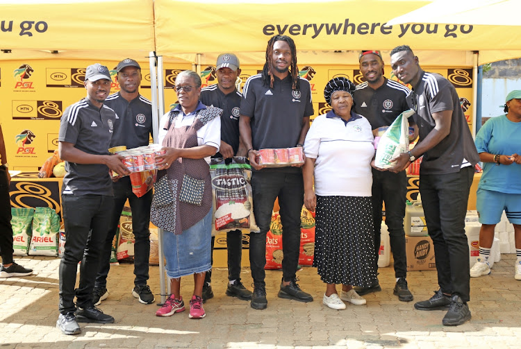 Orlando Pirates and PSL officials handover food during the 2023 MTN8 Goal for charity at Little Rose Center in Soweto.