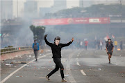 A demonstrator gestures during clashes with police during a university students' protest outside the Indonesian parliament building in Jakarta, Indonesia, on September 24 2019