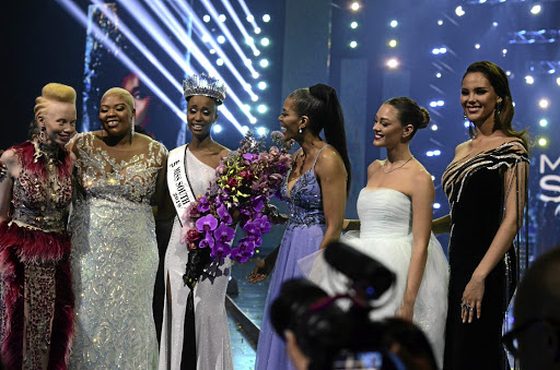 Zozibini Tunzi, centre, who was crowned Miss SA on Friday night, is congratulated by the judges - Thando Hopa, Anele Mdoda and Connie Ferguson.