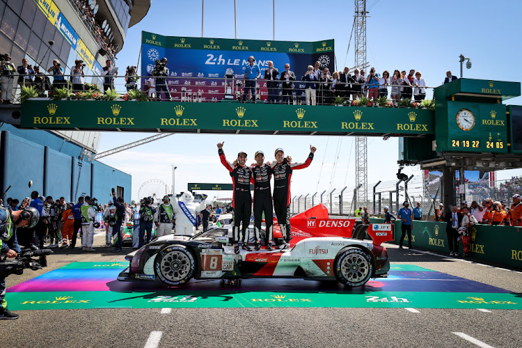 Race winners of the No.8 Toyota Gazoo Racing GR010 Hybrid of Sebastien Buemi, Brendon Hartley and Ryo Hirakawa celebrate at the end of the Le Mans 24 Hours Race on June 12, 2022 in Le Mans, France.