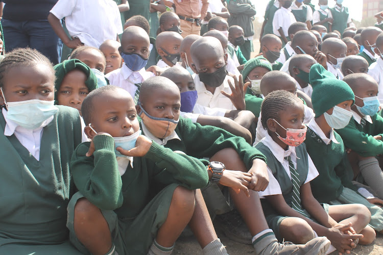 Athi River primary school pupils listening to Mavoko MP Patrick Makau at the institution in Machakos county on September 15.