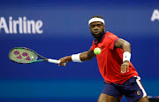Frances Tiafoe of the United States hits a shot against Andrey Rublev of Russia.