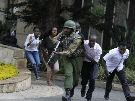 A security officer helps evacuate survivors from Dusit Hotel after a terrorist bomb attack on January 15, 2019. Photo/Monicah Mwangi