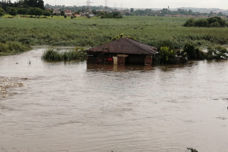 An elderly woman and two men were rescued by EMS from a flooded house in Kliptown.