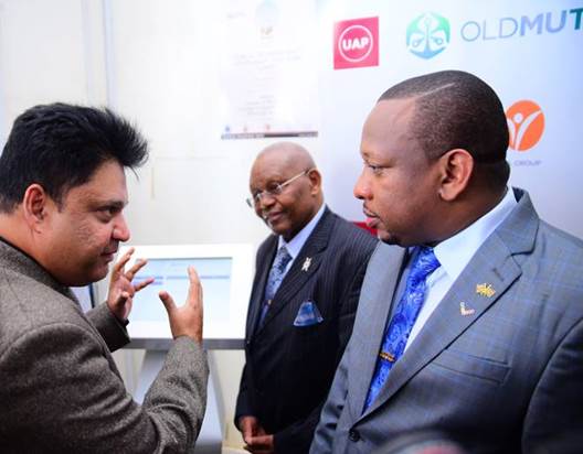 H.E Governor Mike Mbuvi Sonko and UAP Old Mutual Faulu Group Foundation Chairman, Dr. Peter Muthoka learn how the queue management system works during its launch at Mama Lucy Kibaki Hospital.