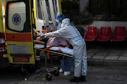 Medical workers wearing personal protective equipment carry a patient on a stretcher, as she arrives on an ambulance at the coronavirus disease (COVID-19) ward of the Ippokrateio General Hospital in Thessaloniki, Greece, November 3 2021. 
