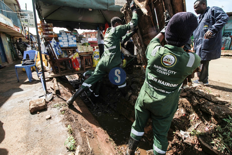 Nairobi county workers load garbage into a truck at Kangemi on February 28, 2024.