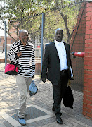 Welcome Msomi and Benny Mangolela happily leaving Palm Ridge magistrate's court./ Veli Nhlapo