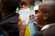 A budding bibliophile enjoying the story and live reading at the 2019 World Read Aloud Day. 