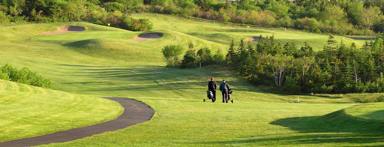 Two golfers walk the greens on a course on Avalon Peninsula in Newfoundland. 