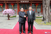 North Korean leader Kim Jong Un shakes hands with Chinese President Xi Jinping, as he paid an unofficial visit to Beijing, China. 