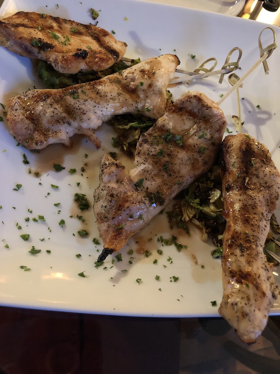 Pomegranate glazed grilled chicken tenders over tender brussels sprout bits.