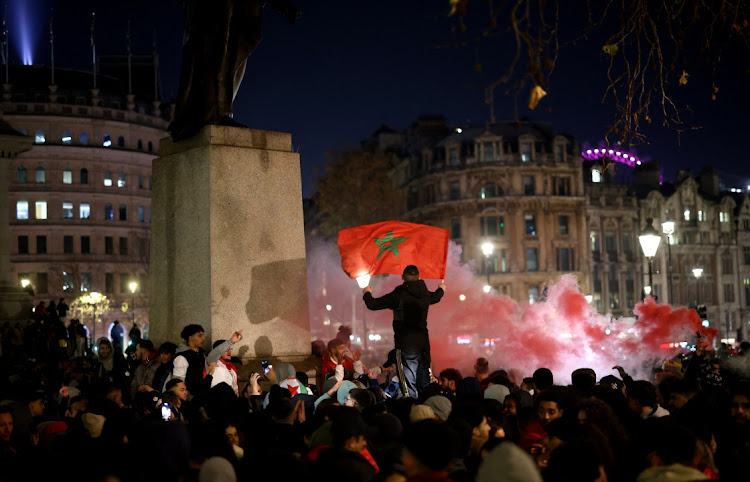 Morocco fans in London celebrate the country's national team beating Portugal 1-0 in the 2022 Wordl Cup quarterfinals to become the first African team in histotyr to reach the the semifnals.