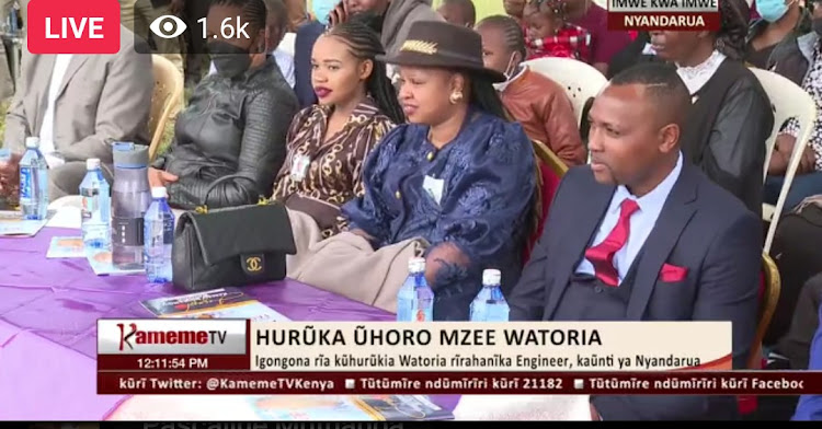 Wambui Kajim in a brown dress, Kiengei's wife Mugure and Kiengei during the burial service in Nyandarua country