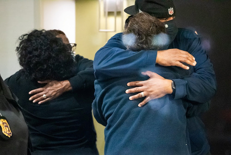 People embrace after learning that their loved one was safe after a mass casualty shooting at the FedEx facility in Indianapolis, Indiana, U.S. April 16, 2021.