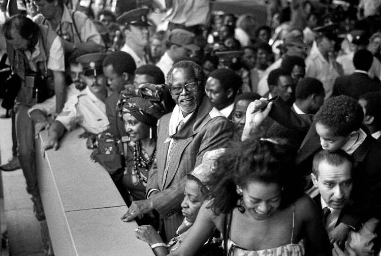 Oliver Tambo at Jan Smuts airport on December 13 1990. His wife, Adelaide, is on his left and Winnie Mandela is on his right. Son Dali is behind him